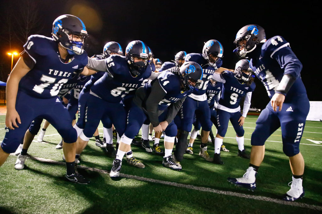 The Sultan High School football team gets fired up before its annual Black and Blue Bowl rivalry game against Granite Falls on Friday night. It marked the first Snohomish County prep football game in more than 15 months. (Kevin Clark / The Herald)
