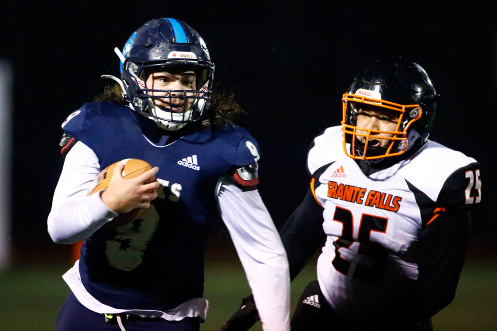 Sultan’s Zane Sailor races down the sideline as Granite Falls’ Luis Hernandez gives chase. (Kevin Clark / The Herald)
