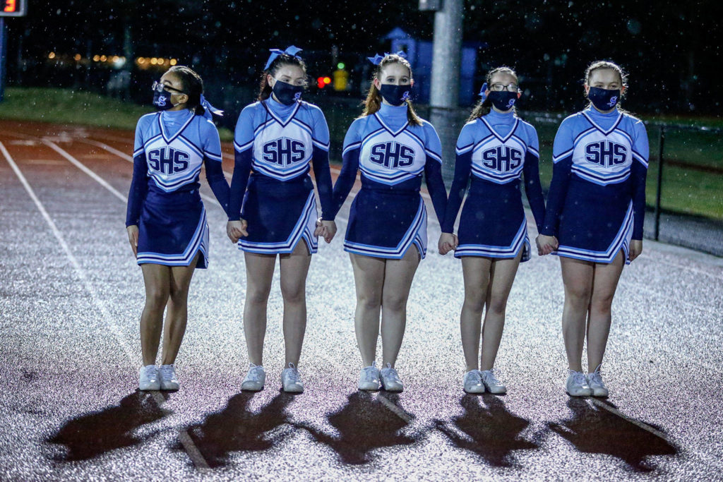 Sultan cheerleaders line up to greet Granite Falls cheerleaders. (Kevin Clark / The Herald)
