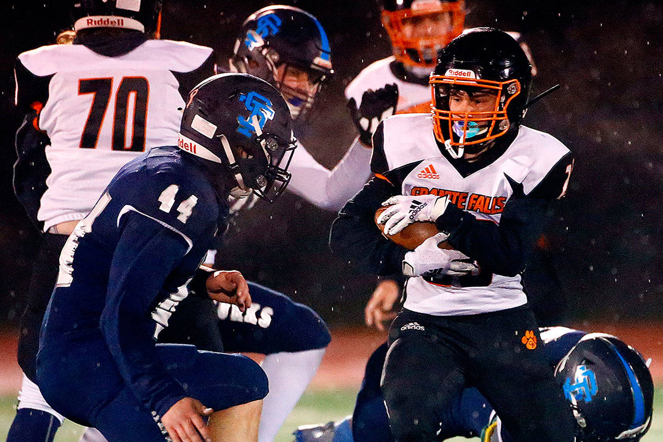 Granite Falls' Kaleb Roberts rushes with Sultan's Kaden Harwick closing Friday night in Sultan on February 26, 2021 (Kevin Clark / The Herald)