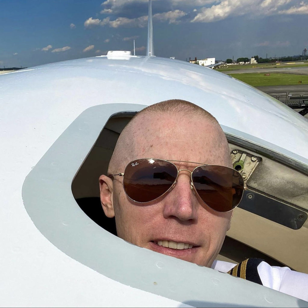 Kelsey Hughes pokes his head out of the emergency escape hatch on a Boeing 747 at Daniel K. Inouye International Airport in Honolulu. (Kelsey Hughes) 
