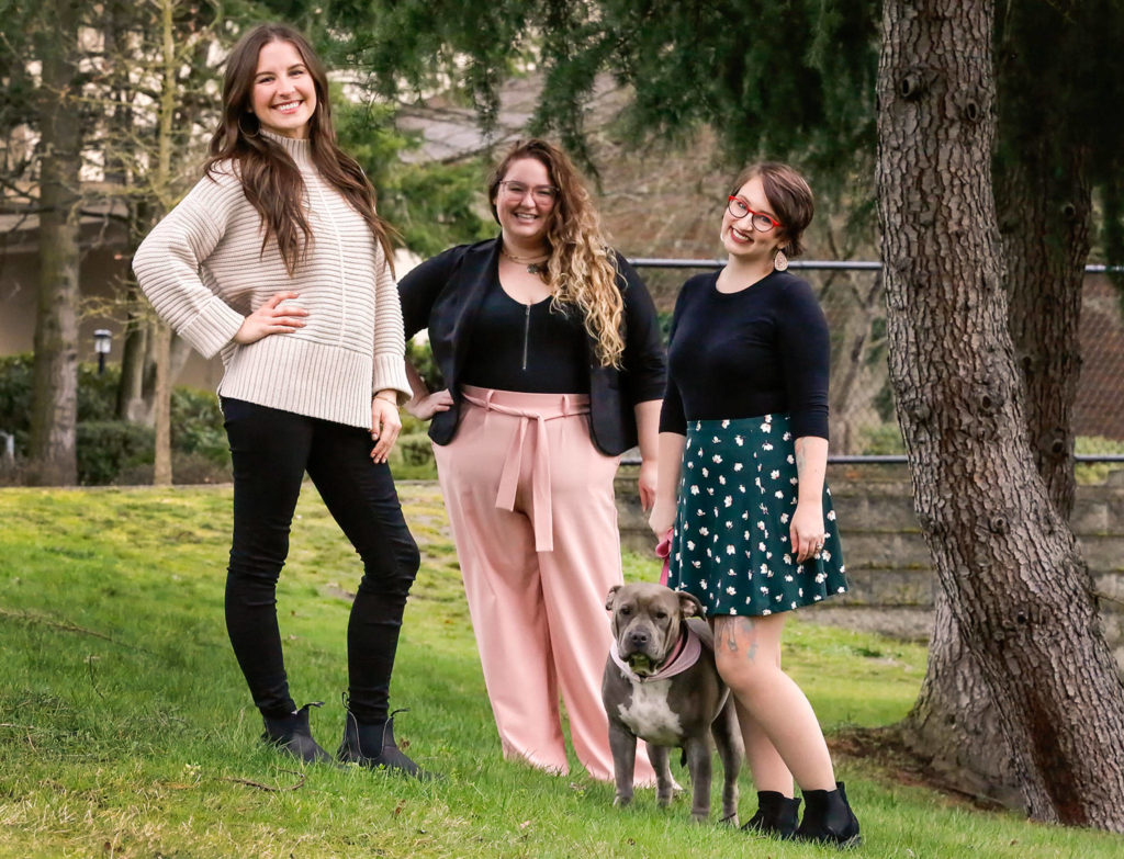 Erin Staadecker (left), Jael Weinburg (center) and Kaylee Allen, with Rosie the dog, formed the Edmonds firm Creative Dementia Collective. The company helps memory care patients and caregivers by providing art, music and other creative therapies. (Kevin Clark / The Herald)
