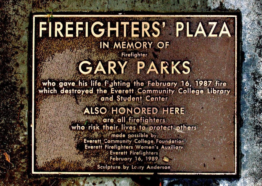 A bronze plaque is fixed in the walkway at the Gary Parks memorial outside the Everett Community College library. (Dan Bates / Herald file)
