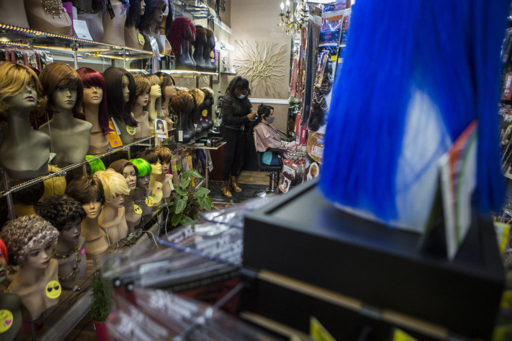 Wigs and hair extensions line the walls and display racks of Decarla’s Beauty Supply & Salon in Everett. (Olivia Vanni / The Herald) 
