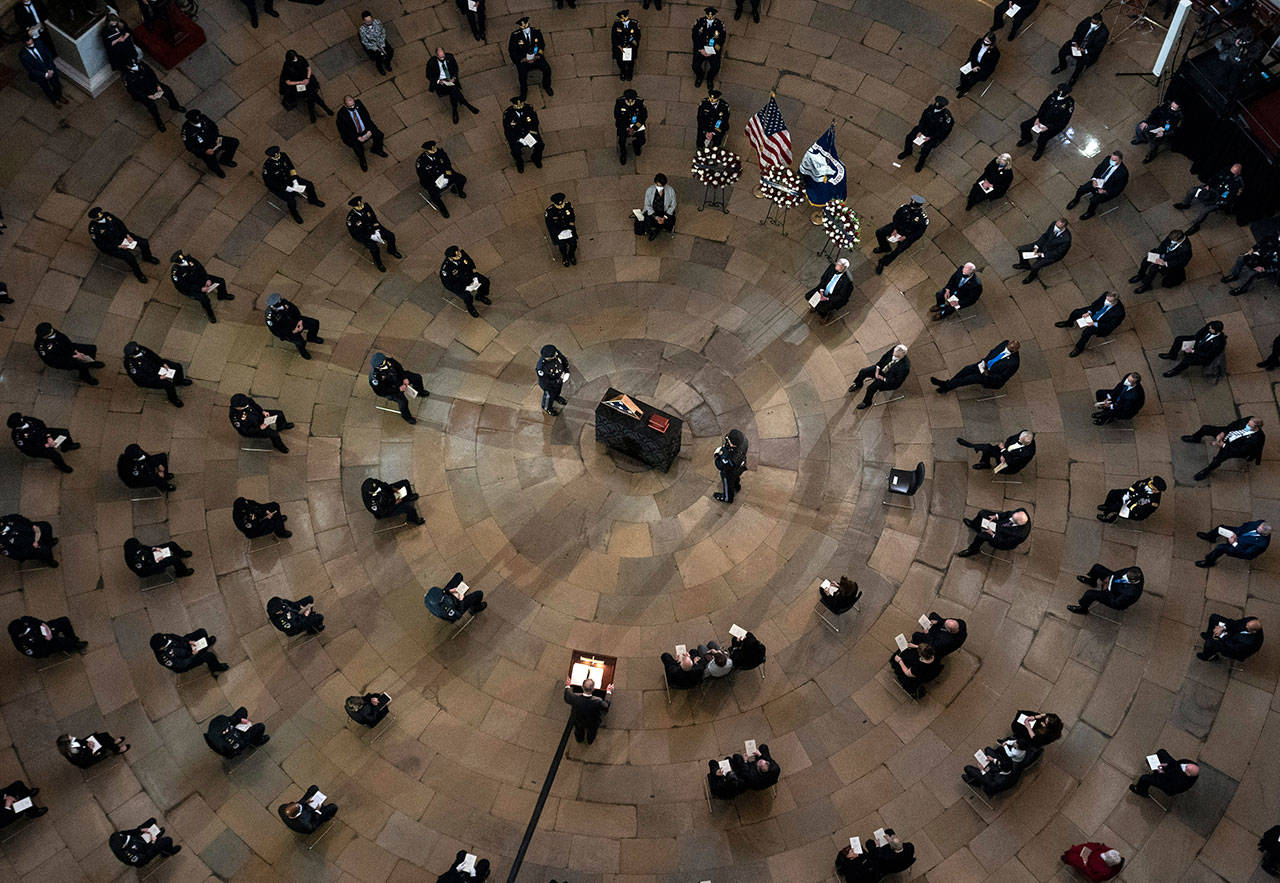 A ceremony memorializes U.S. Capitol Police officer Brian Sicknick, as an urn with his cremated remains lies in honor on a black-draped table at the center of the Capitol Rotunda, Feb. 3, in Washington, D.C. Sicknick was fatally struck in the head during the Jan. 6 attack on the U.S. Capitol. (Kevin Dietsch / Associated Press)
