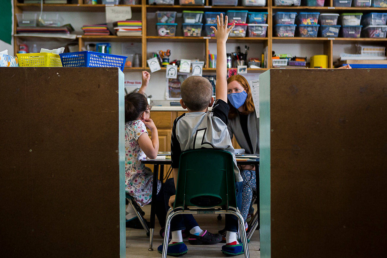 A boy raises his hand during a lesson at Starbright Early Learning Center on Friday, June 5, 2020 in Everett. The Snohomish County Council is expected to vote Wednesday on a measure that would add early learning centers to a spending plan for the Puget Sound Taxpayer Accountability Account. (Olivia Vanni / Herald file)