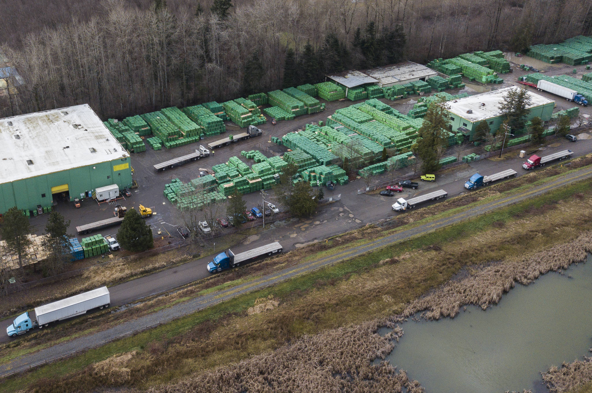 Parked tractor-trailers line the side of 40th Avenue NE in Marysville. The road is in bad shape but limited funds mean the city doesn’t have plans to repair it any time soon. (Olivia Vanni / The Herald)