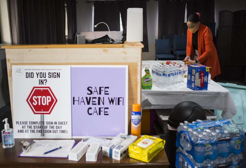 Safe Haven WiFi Cafe founder Ashley Kiboigo stocks the snack table. (Olivia Vanni / The Herald) 

