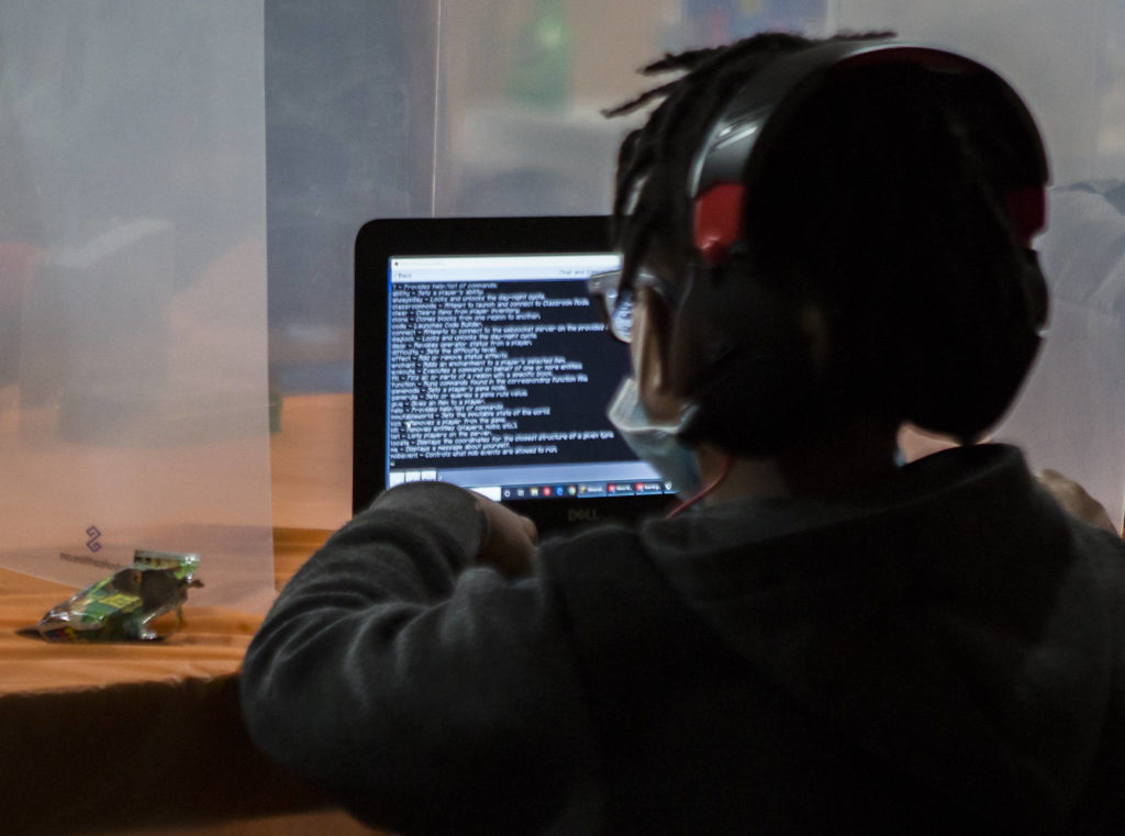 Elwin Pittman writes code for fun after school at the Safe Haven WiFi Cafe in Everett. (Olivia Vanni / The Herald) 
