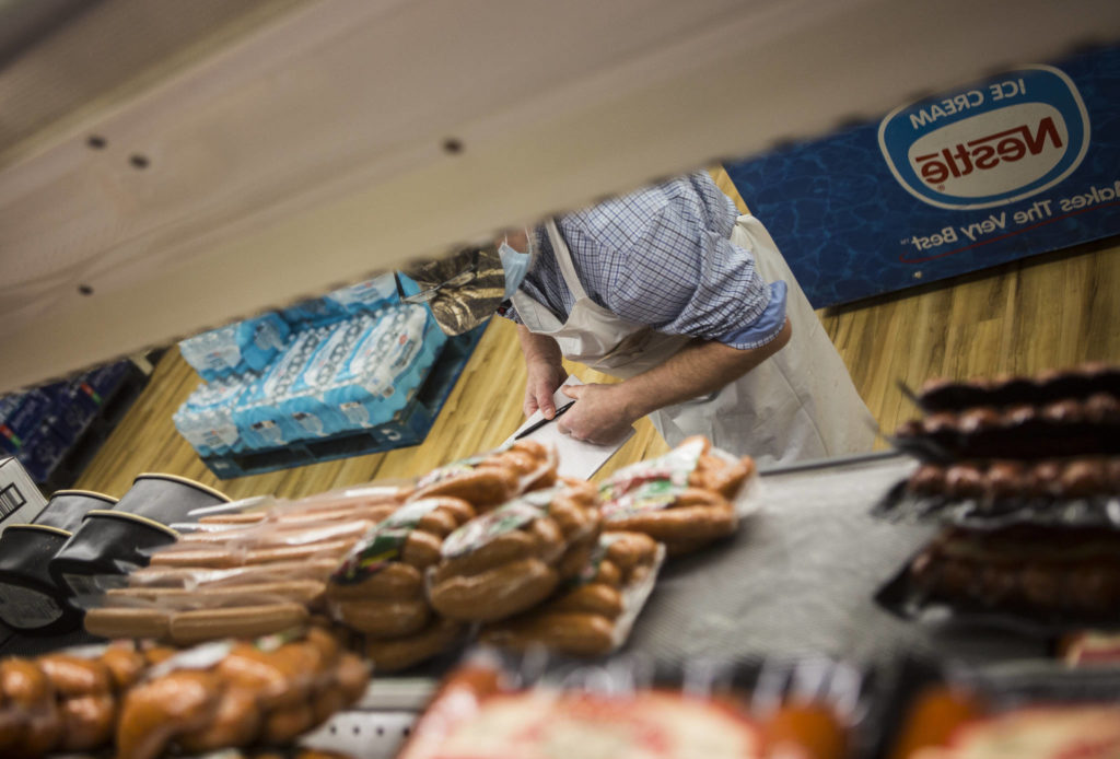 Kevin Ashe inventories meat at the IGA in Darrington, which his family has owned for decades. (Olivia Vanni / The Herald)
