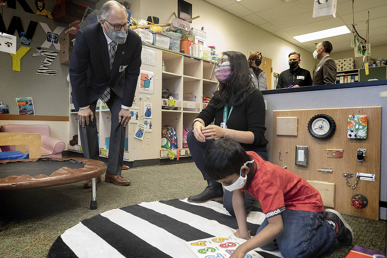 Washington State Governor Jay Inslee speaks with special ed Pre-K teacher Michelle Ling in her classroom at Phantom Lake Elementary School in Bellevue, Wash. Tuesday, March 2, 2021. (Ellen M. Banner/The Seattle Times via AP, Pool)