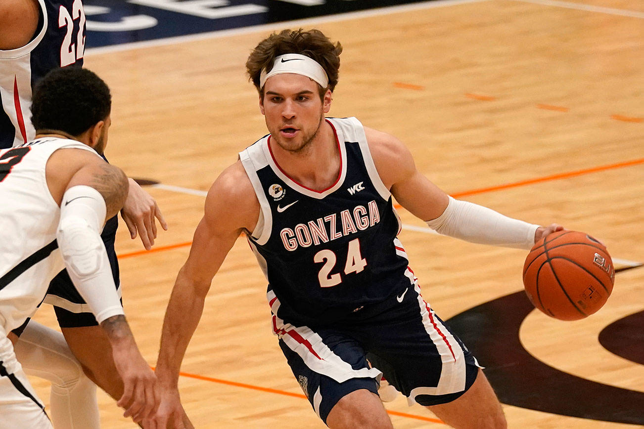 Gonzaga forward Corey Kispert (24), looks to drive against Pacific forward Jeremiah Bailey (13), during the first half of an NCAA college basketball game in Stockton, Calif., Thursday, Feb. 4, 2021. Gonzaga won 76-58. (AP Photo/Rich Pedroncelli)