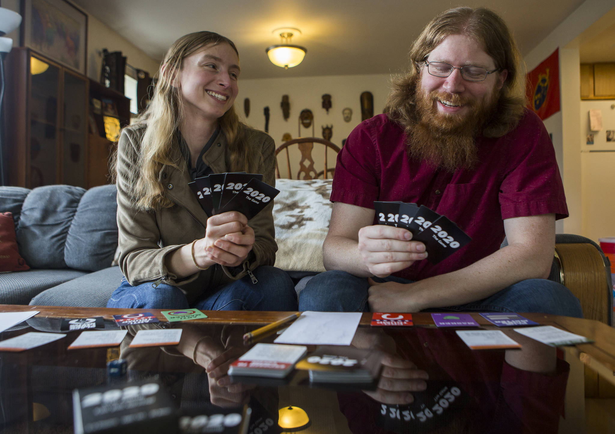 2020: The Game creators Kathryn Christensen and Jonathan Noble of Bothell display the card game inspired by the crazy, difficult year. (Olivia Vanni / The Herald)