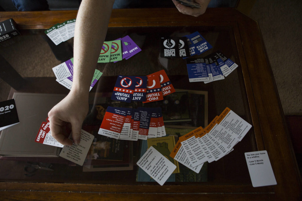 Jonathan Noble lays out the variety of cards with topics and scenarios you must navigate to “survive” 2020. (Olivia Vanni / The Herald)
