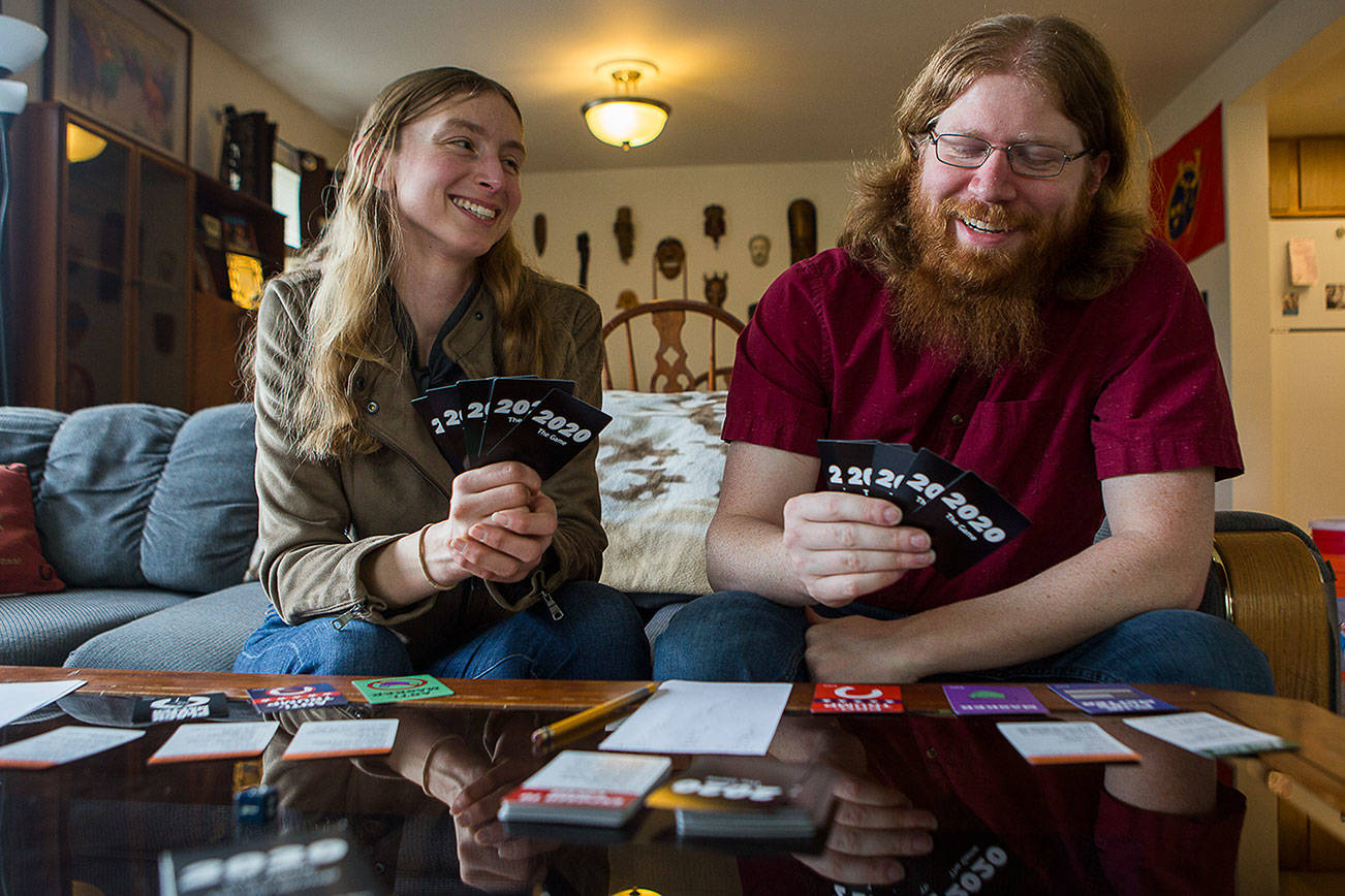 2020 The Game creators Kathryn Christensen and Jonathan Noble display the card game they created at their home on Saturday, March 6, 2021 in Bothell, Wa. (Olivia Vanni / The Herald)