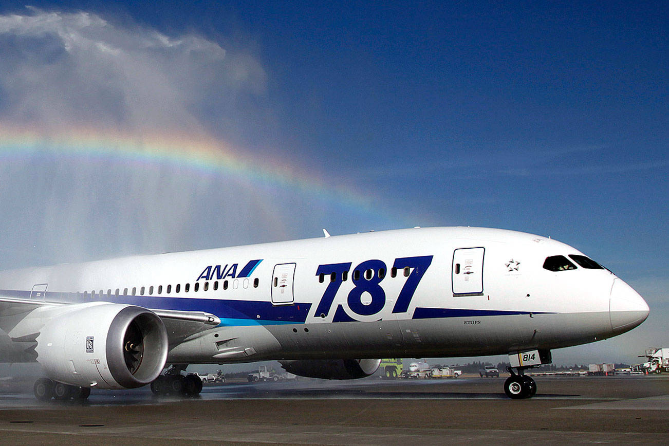 A Boeing 787 operated by All Nippon Airways taxis under a rainbow created by fire trucks at Seattle-Tacoma International Airport, Monday, Oct. 1, 2012, in Seattle, during an official welcome ceremony after it landed on the first day of service for the aircraft on ANA's Seattle-Tokyo route. (AP Photo/Ted S. Warren)