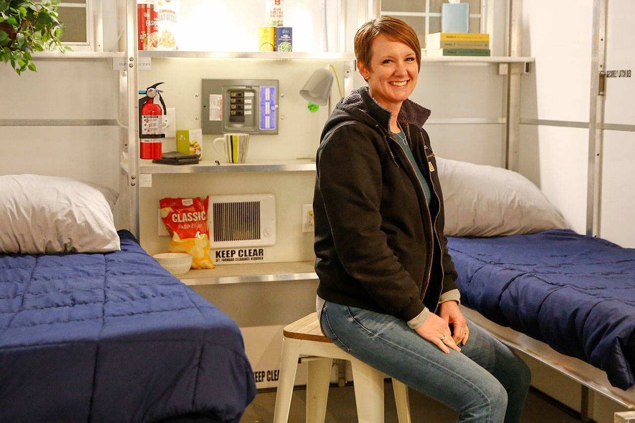 Amy King, chief executive of Pallet, the Everett maker of small shelters, sits in a demonstration model of its 64-square-foot version, in January. (Kevin Clark / The Herald)