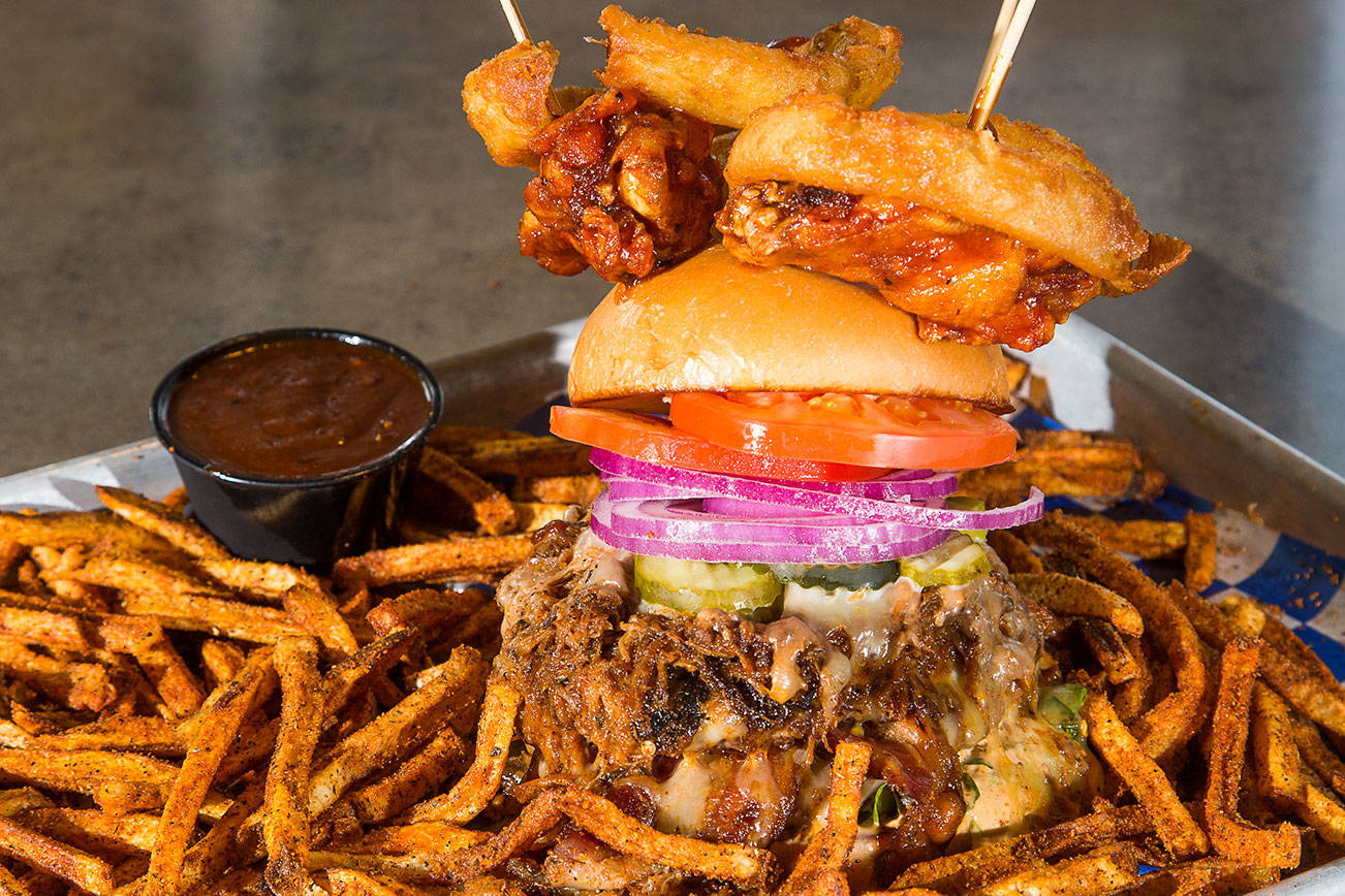 Scuttlebutt Brewing Company chef Jeremiah Marleau created The Triple Threat burger with three meats and ghost pepper jack cheese among the ingredients. Shot on Monday, March 8, 2021 in Everett, Washington.  (Andy Bronson / The Herald)