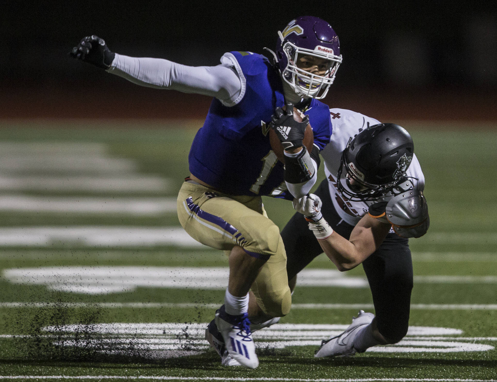 Lake Stevens’ Jayden Limar runs through a tackle during the Vikings’ 26-7 win over Archbishop Murphy on Saturday night in a season-opening showdown of perennial Snohomish County prep football powers. (Olivia Vanni / The Herald)