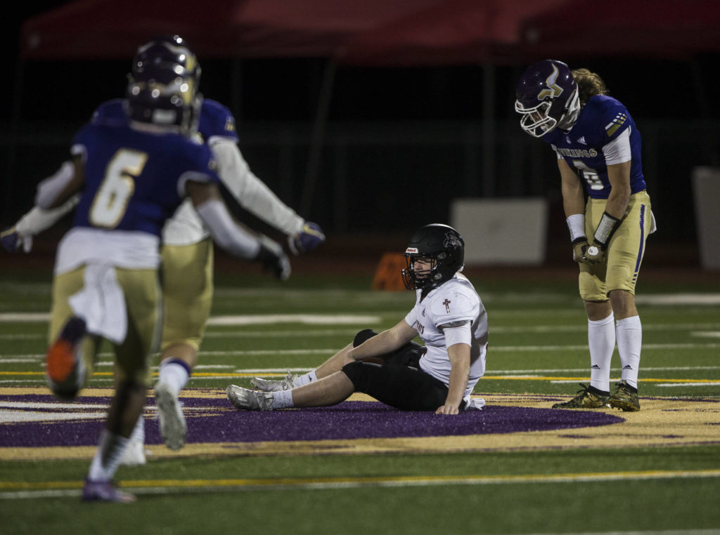 Lake Stevens’ Drew Carter taunts Archbishop Murphy quarterback Colton Johnson after sacking him Saturday during the high school football game in Lake Stevens. (Olivia Vanni / The Herald)
