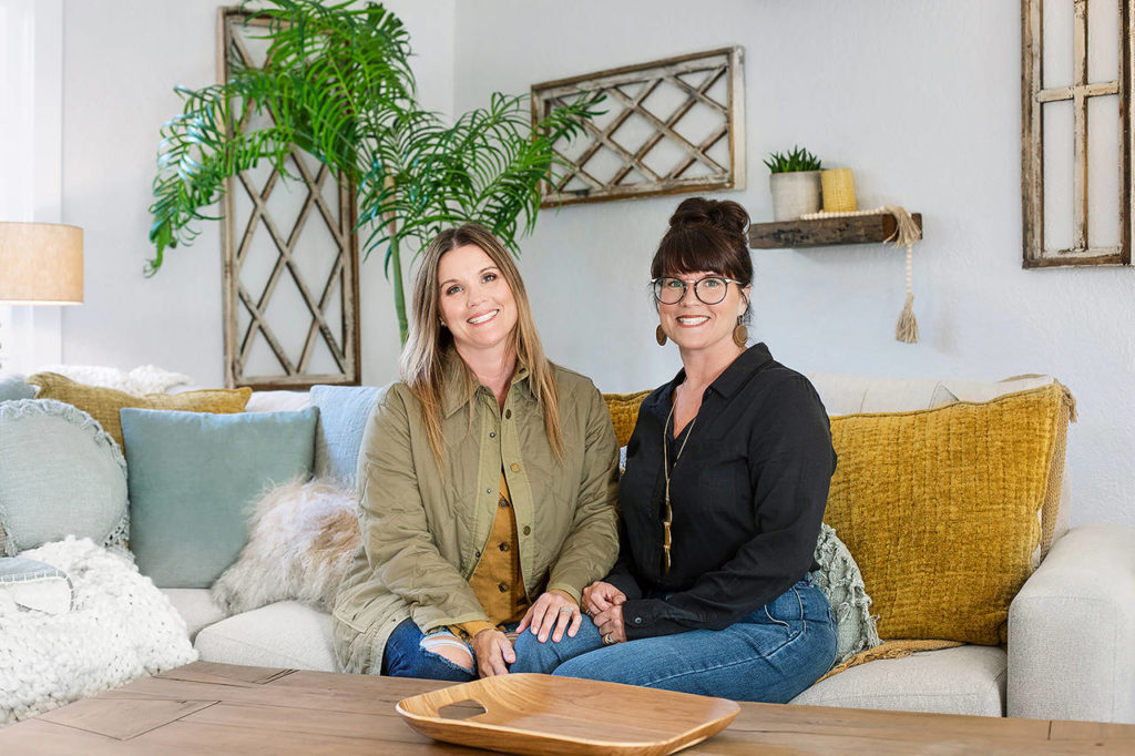 Leslie Davis (left) and her twin sister, Lyndsay Lamb, pose in the den of a house they remodeled in Snohomish, as seen on the HGTV series “Unsellable Houses.” (HGTV)
