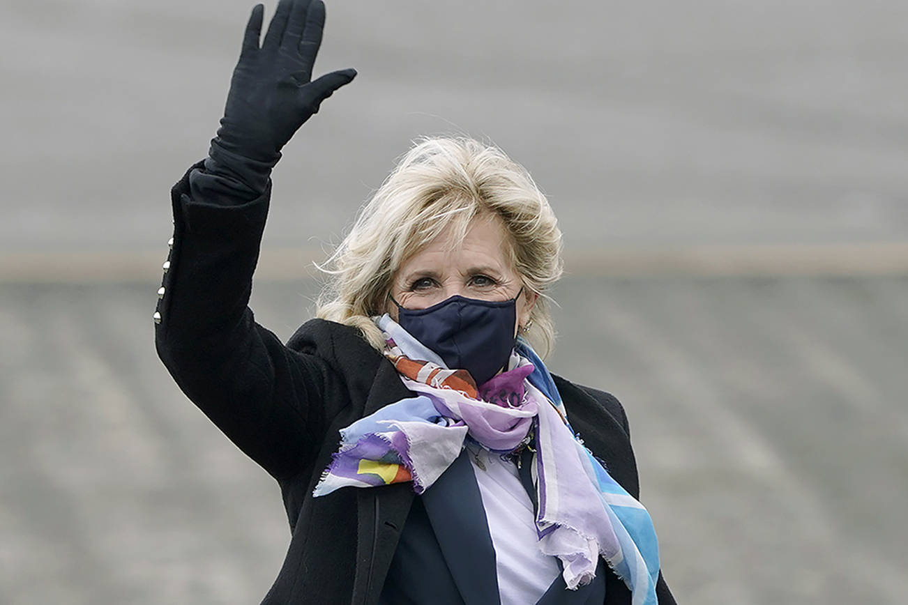 First lady Jill Biden waves after she arrived at Joint Base Lewis-McChord, Monday, March 8, 2021, in Washington state. Biden is scheduled to tour a portion of the base and visit with military families on Tuesday. (AP Photo/Ted S. Warren)