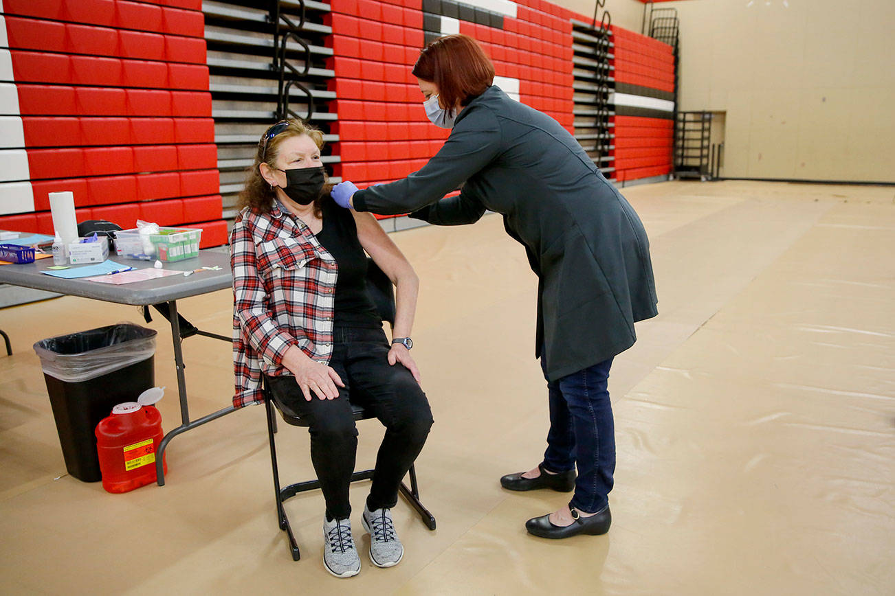 Berinda Wolitarsky gets her second vaccine shot Saturday morning at Snohomish High School on March 13, 2021. (Kevin Clark / The Herald)
