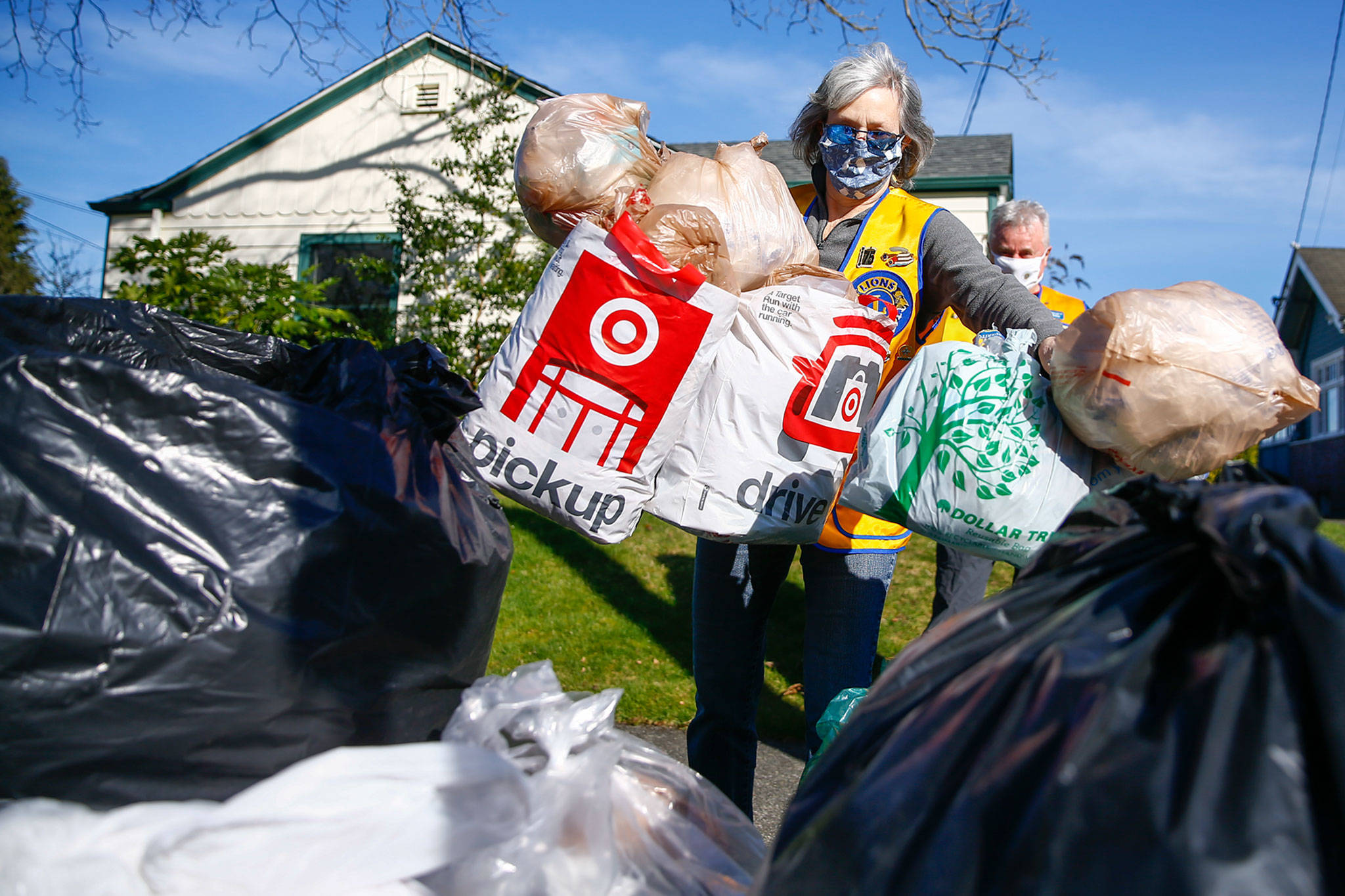 Renee Dierling adds plastic bags to the collection pile Friday afternoon in Snohomish. The bags are sent to a company that donates benches made from recycled materials, including plastic bags. (Kevin Clark / The Herald)