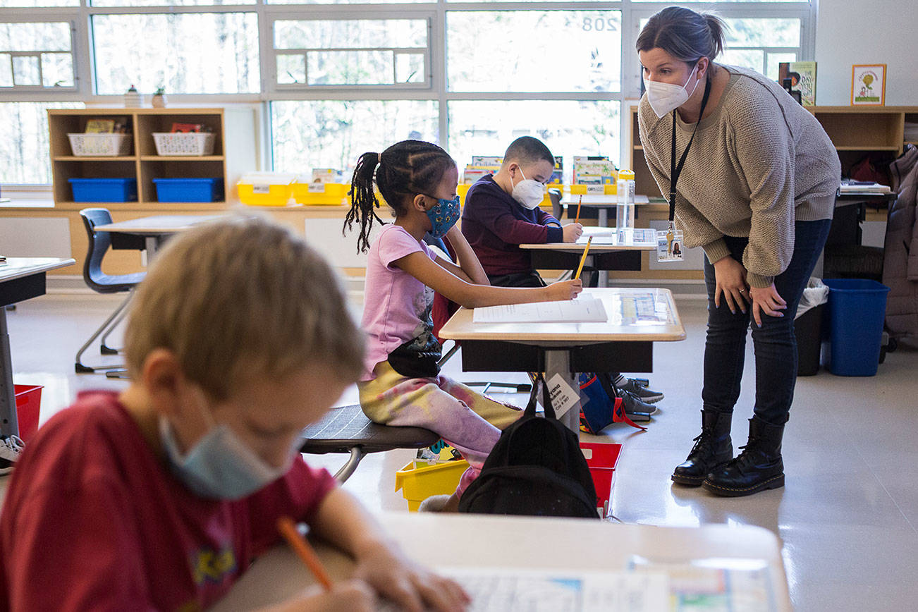 Jessica Cain, right, answers a question about an assignment for Solyana Makele during her hybrid second grade class on Friday, March 12, 2021 in Lynnwood, Wa. (Olivia Vanni / The Herald)