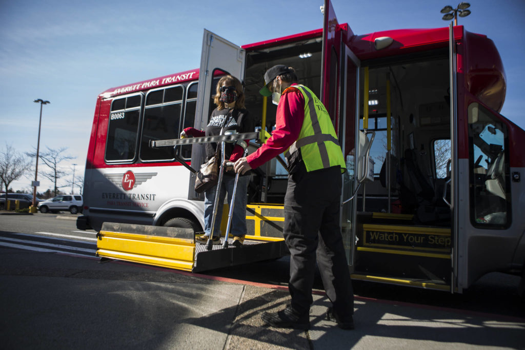 Leigh Spruce gets off of an Everett paratransit bus Thursday at the Everett Mall. She lives in Mill Creek and works in Everett, where the city is working on an ADA transition plan identifying right-of-way barriers. (Olivia Vanni / The Herald) 

