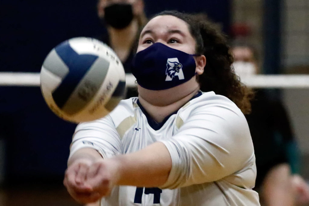 Arlington’s Laura Meno digs Thursday night at Arlington High on March 11, 2021. (Kevin Clark / The Herald)
