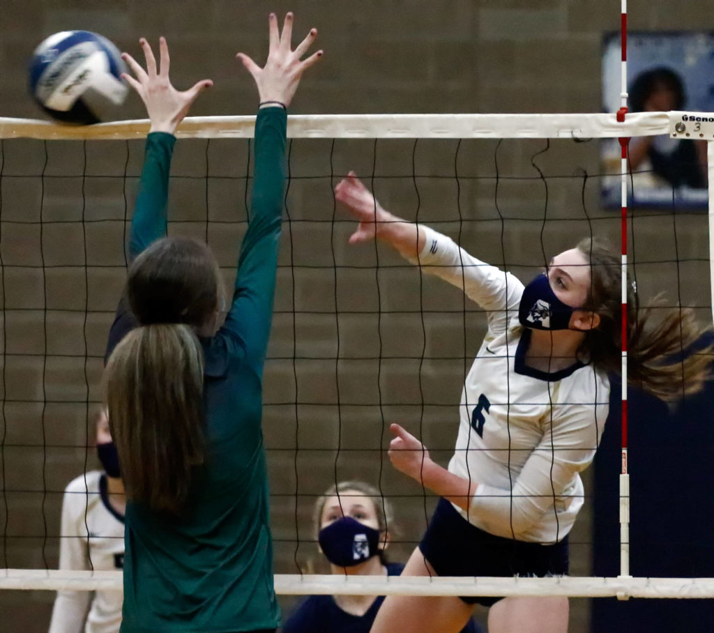 Arlington’s Malia Shepherd spikes Thursday night at Arlington High on March 11, 2021. (Kevin Clark / The Herald)
