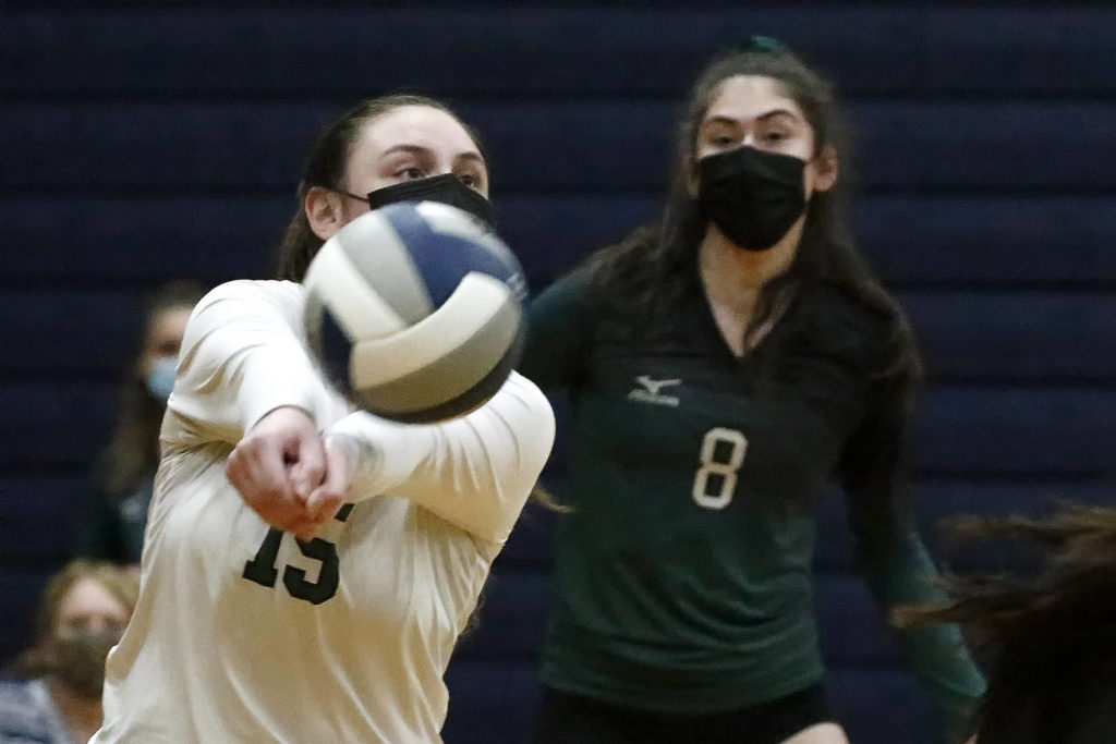 Jackson’s Rosa Ursino dips with Erin Ingram (right) against Arlington Thursday night at Arlington High on March 11, 2021. (Kevin Clark / The Herald)
