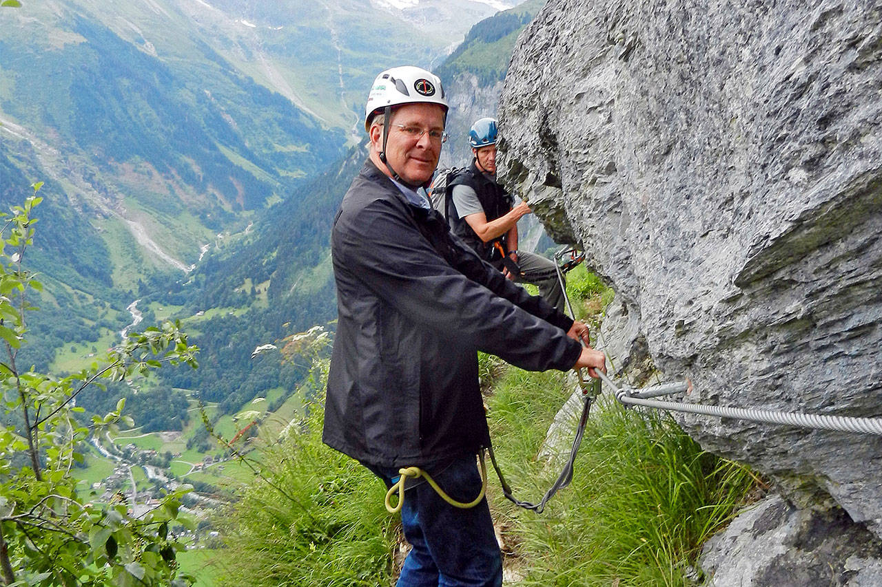 Buckled up and hanging on for dear life, Rick Steves embarks on the via ferrata. (Rick Steves’ Europe)