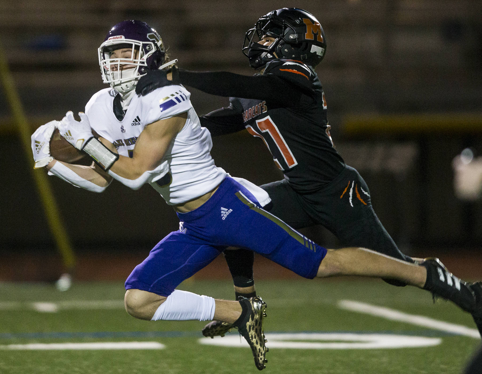 Lake Stevens’ Drew Carter (left) dives for a catch past Monroe’s Trey Lane during a game on March 12, 2021, in Monroe. (Olivia Vanni / The Herald)