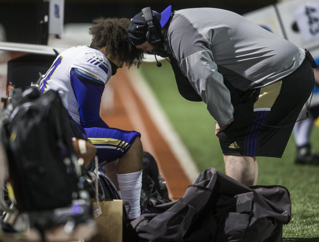 A Lake Stevens coach comforts one of his players during the game on Friday, March 12, 2021 in Monroe, Wa. (Olivia Vanni / The Herald)
