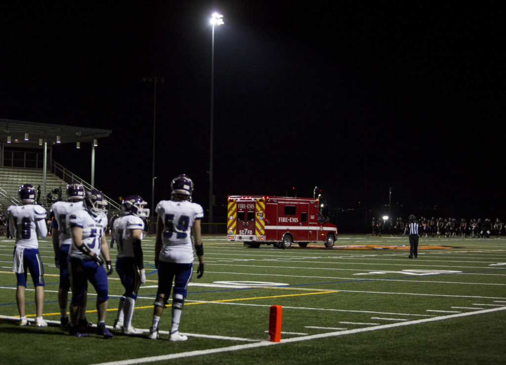 An ambulance makes its way off the field during the game between Lake Stevens and Monroe on Friday, March 12, 2021 in Monroe, Wa. (Olivia Vanni / The Herald)
