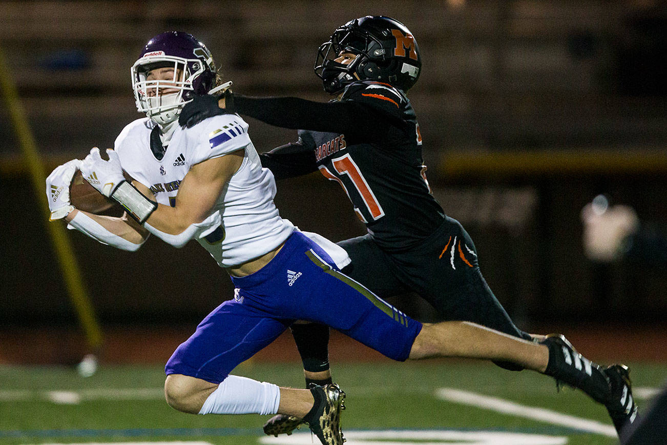 Lake Stevens' Drew Carter makes a catch past Monroe's Trey Lane during the game on Friday, March 12, 2021 in Monroe, Wa. (Olivia Vanni / The Herald)