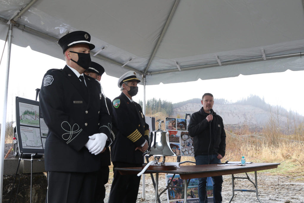 Dayn Brunner talks about his sister, Summer Raffo, who was killed in the Oso landslide seven years ago. A memorial for the victims was held at the site on Monday. (Andy Bronson / The Herald) 
