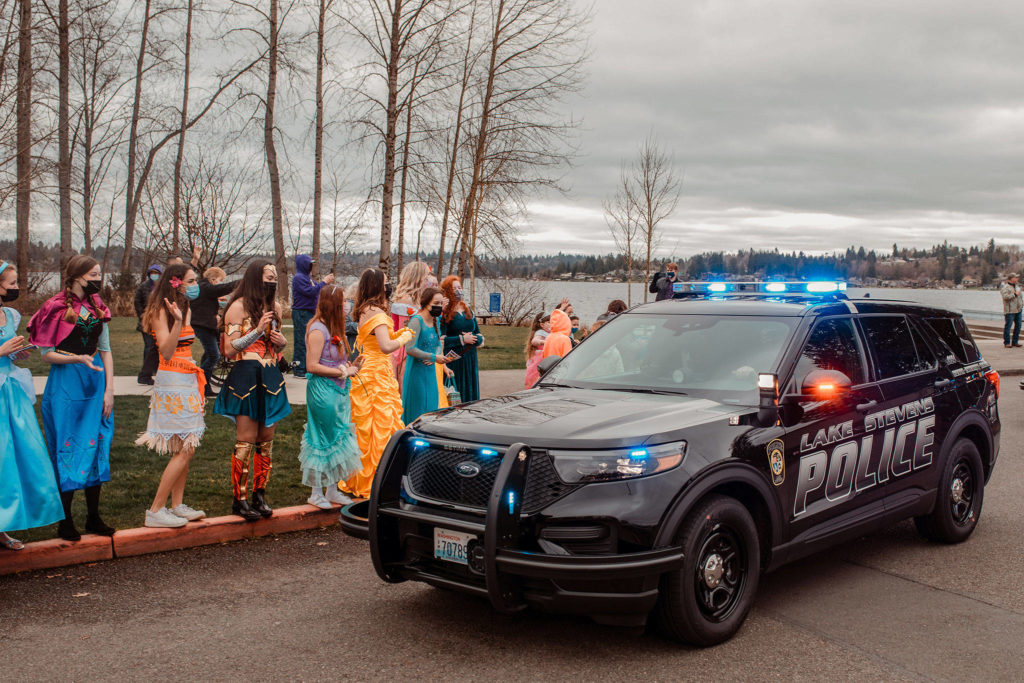 A police car drives through a fundraiser for Bethany Erickson and her family at Lundeen Park in Lake Stevens on March 6. (Stephanie Walls)
