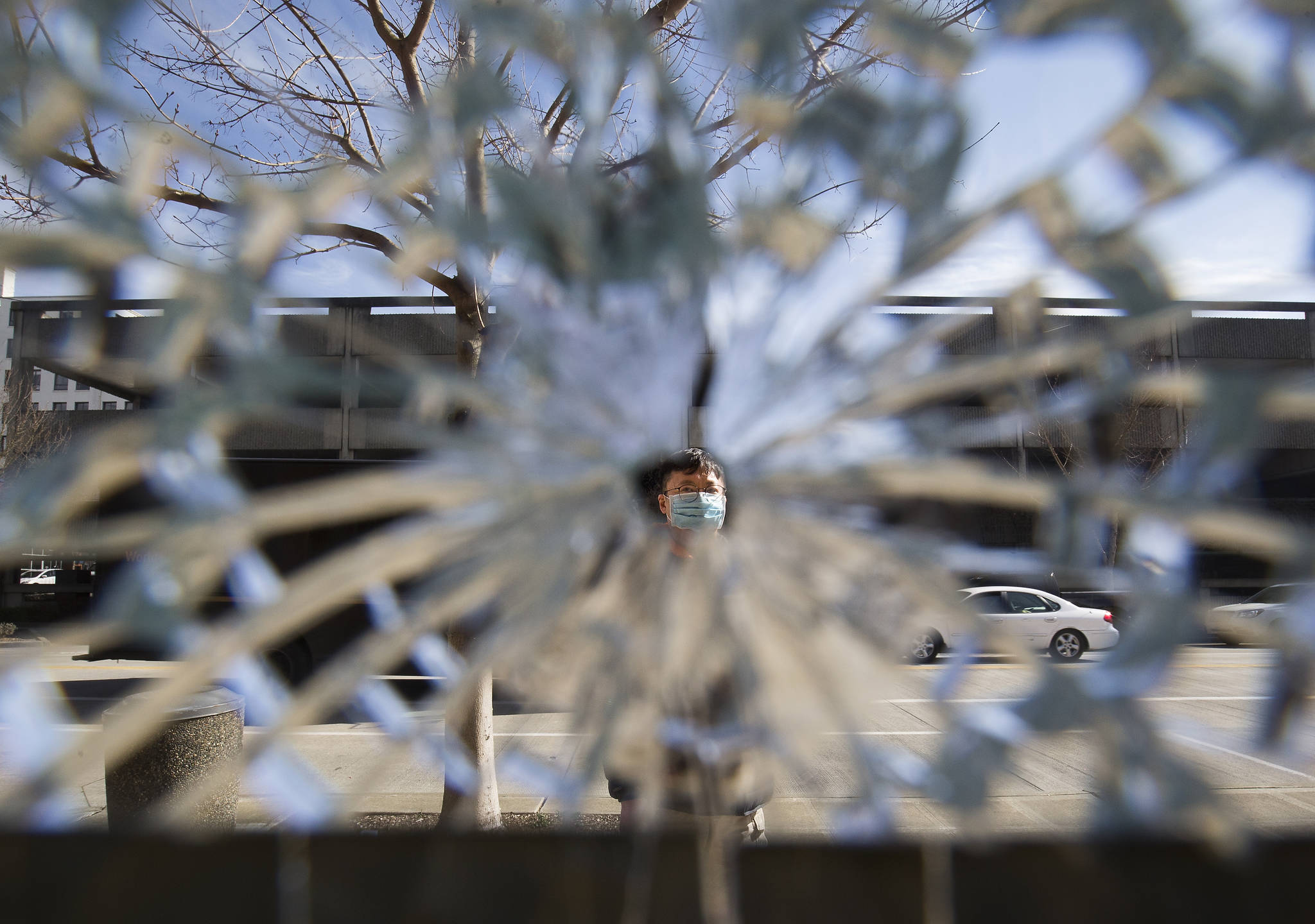 Andrew Ho is seen through one of several windows smashed at the Soup Nazi Kitchen on Hoyt Avenue in Everett. Before even opening, his restaurant was vandalized due to its name. He is now removing “Nazi” from the name. (Andy Bronson / The Herald)