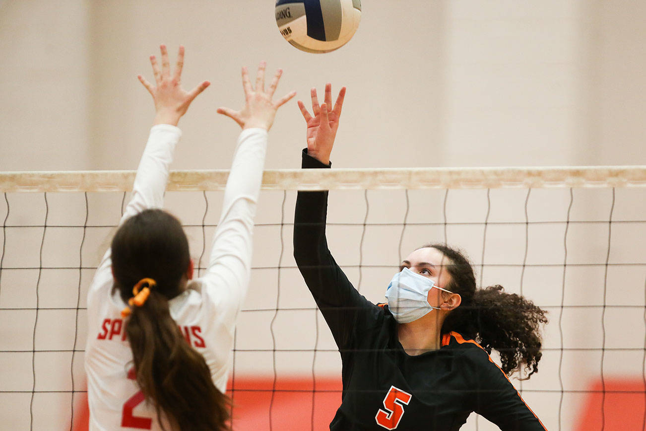 Monroe's Krista Norton lifts the ball over Stanwood's Lili Jones as the two teams met in a volleyball game on Wednesday, March 17, 2021 in Stanwood, Washington.  (Andy Bronson / The Herald)