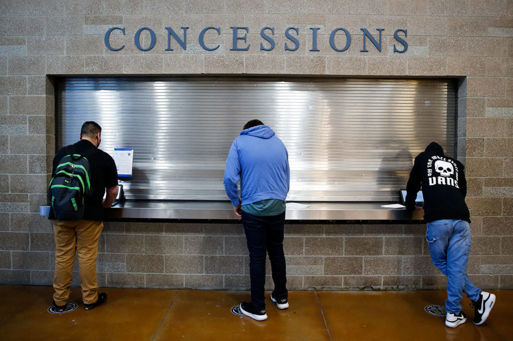 Ninth-grade students complete the health screening Friday morning at Arlington High School. (Kevin Clark / The Herald)
