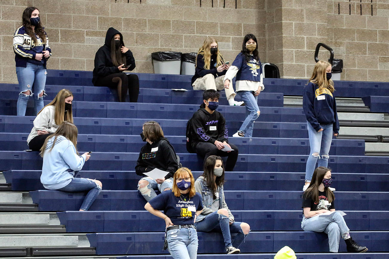 Freshmen await the start on the assembly at Arlington High School Friday morning in Arlington on March 19, 2021. (Kevin Clark / The Herald)