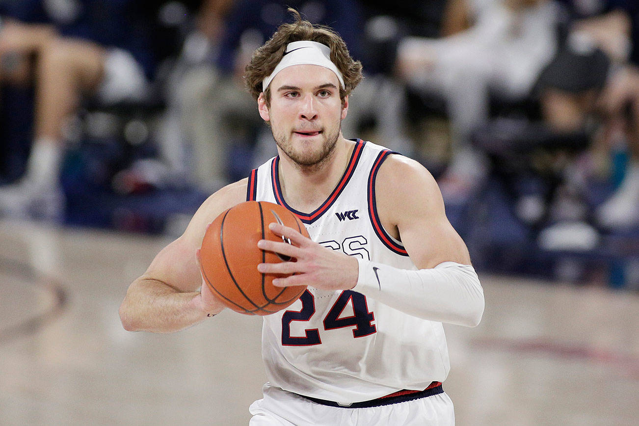 FILE - Gonzaga forward Corey Kispert prepares to pass the ball during the first half of an NCAA college basketball game against Loyola Marymount in Spokane, Wash., in this Saturday, Feb. 27, 2021, file photo. Kispert has made The Associated Press All-America first team, announced Tuesday, March 16, 2021. (AP Photo/Young Kwak, File)