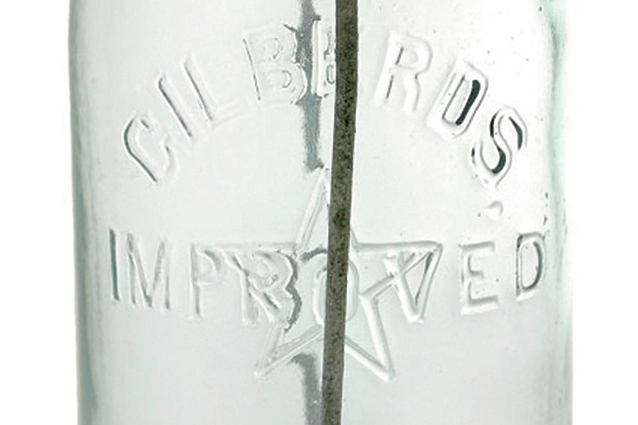The lid of this jar has an iron clamp closure, which added to its value because it too was identified in the glass as patented by Gilberd. It sold for $188. This type of jar was used over and over by a housewife making pickles or canned vegetables or fruit. Almost all food was homemade, cooked in season, and stored for the winter. (Cowles Syndicate Inc.)
