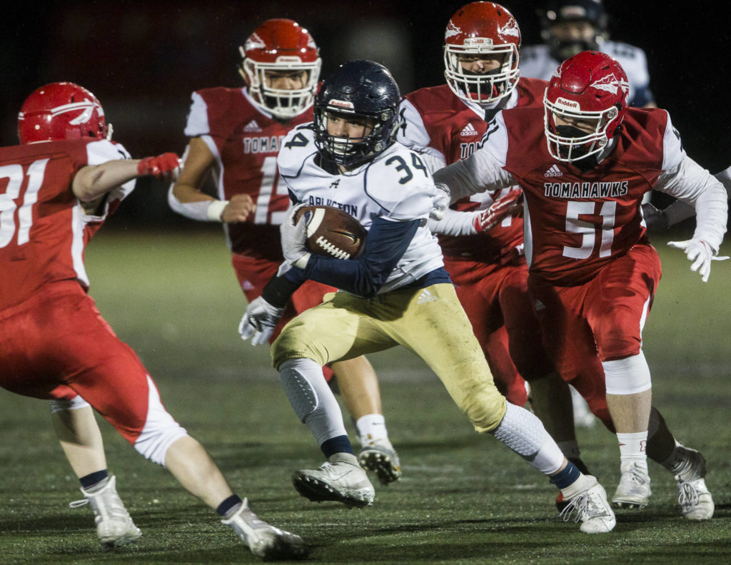 Marysville-Pilchuck’s defense chases down Arlington’s Spencer Fischer during the game on Friday, March 19, 2021 in Marysville, Wa. (Olivia Vanni / The Herald)

