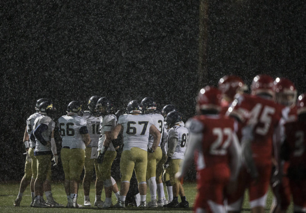 Marysville-Pilchuck and Arlington huddle for a timeout during the game on Friday, March 19, 2021 in Marysville, Wa. (Olivia Vanni / The Herald)
