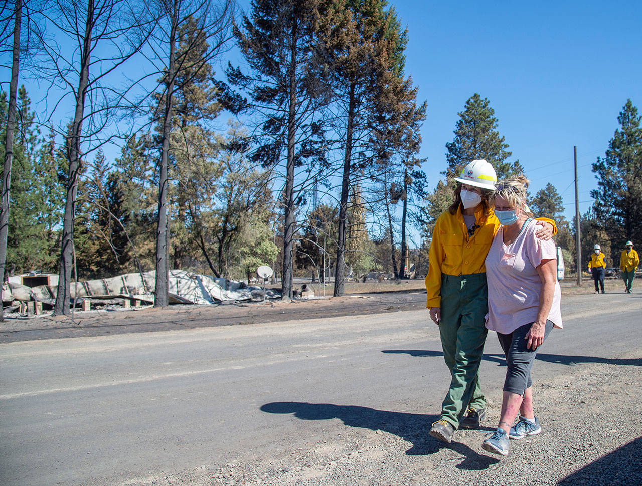 Washington state Commissioner of Public Lands Hilary Franz (left) walks with Mayor Chris Ferrell, Sept. 9, 2020 in Malden. Franz toured the town and made the case for more funding for firefighting resources. Most of the buildings in Malden, which is about five miles west of Rosalia, were destroyed by wind-driven wildfire on Labor Day. (Jesse Tinsley / The Spokesman-Review via AP)