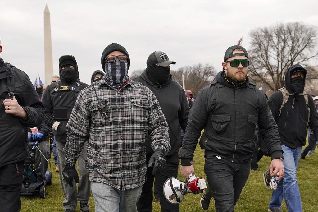 In this Jan. 6 photo, Proud Boys including Joseph Biggs (left) and Ethan Nordean (with megaphone) walk toward the U.S. Capitol in Washington, in support of President Donald Trump. (AP Photo/Carolyn Kaster, file)
